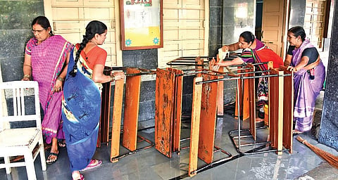 Women staff clean furniture in a classroom of a government school in Hyderabad as schools will re-open from February 1 | RVK Rao