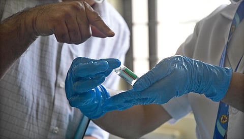 A medic shows a COVID-19 vaccine vial (Photo | Ashish Krishna, EPS)