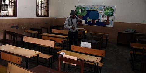A worker seen spraying sanitizer at a school premises. (Photo | Parveen Negi, EPS)