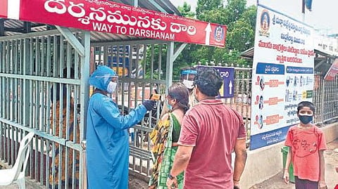 Devotees undergoing thermal screening at Kanaka Durga temple in Vijayawada I P Ravindra Babu