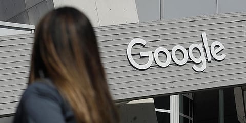 A file photo a woman walks below a Google sign on the company's campus in Mountain View, Calif.  (Photo | AP)