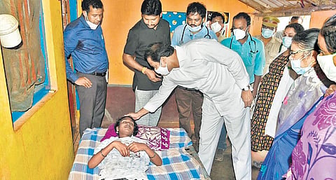 Deputy Chief Minister Alla Kali Krishna Srinivas consoles a patient at Komerapalle village in Denduluru mandal of West Godavari district on Friday | Express