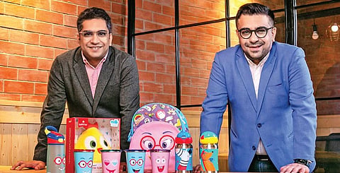 Siddharth and Sumit Suneja with the line of products from Rabitat, their back-to-school collection for kids; (below) a snapshot from their childhood days