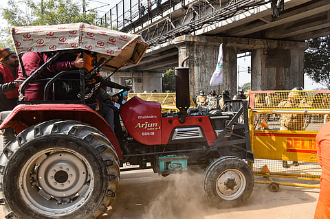 Farmers attempt to break a police barricade during the 'Kisan Gantantra Parade'  in Delhi. (Photo | EPS)
