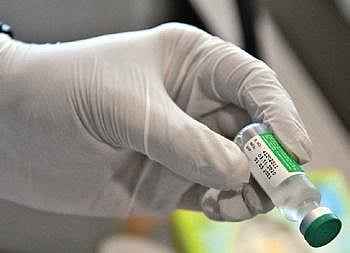 A health worker with a vial of the Covishield vaccine   | Ashishkrishna HP