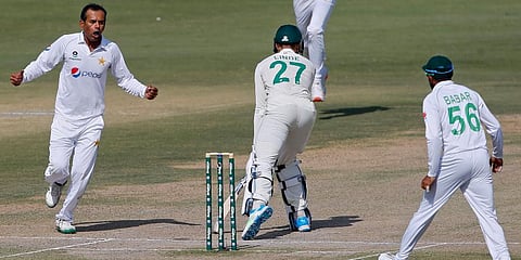 Pakistan's spinner Nauman Ali (L) celebrates after taking the wicket of South Africa's George Linde (27) during the fourth day of the first Test match at the National Stadium, in Karachi. (Photo | AP)