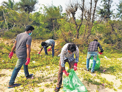 Youth cleaning up a beach near Ratti village in Srikakulam district I Express