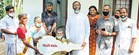 Fr Davis Chiramel handing over Raveendran the key to his house which was built by South Florida Kerala Samajam and American Malayalis | Express