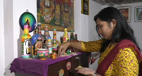 Bhagyasri Sahoo with a collection of Pattachitra artwork in Rourkela (Photo | Express)