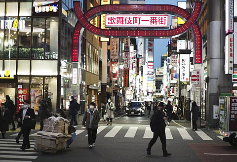 People wearing face masks to help curb the spread of the coronavirus walk across an intersection at Shinjuku neighborhood of Tokyo on Thursday. (Photo | AP)