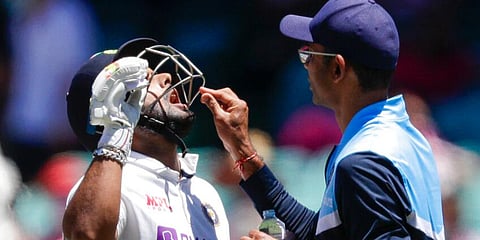Rishabh Pant is given a pain killing tablet during play on day three of the Sydney Test. (Photo | AP)