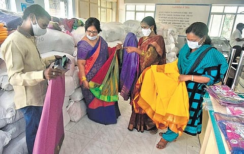 Officials examine a stock of Bathukamma sarees which arrived at Kapra municipal office. (File photo | Vinay Madapu)