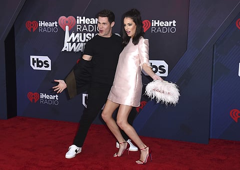 Adam Devine, left, and Chloe Bridges arrive at the iHeartRadio Music Awards.(File  Photo | AP)