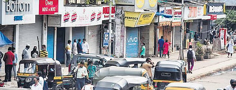 People find themselves in front of closed shops in Mumbai. (Photo | PTI)