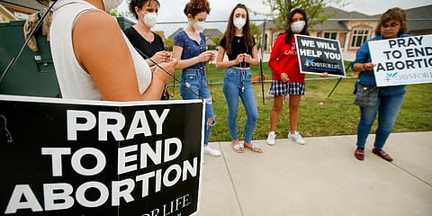 Anti-abortion demonstrators pray and protest outside of a Whole Women's Health of North Texas in McKinney. (Photo | AP)