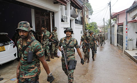 Sri Lankan army soldiers patrol a neighborhood during a cordon and search operation in Colombo (Photo | AP)