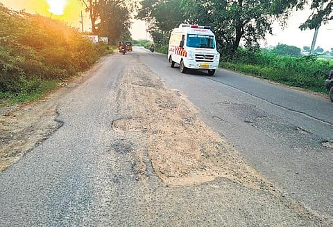 Potholes on the stretch of road from Narsampet to Warangal. (Photo| EPS)