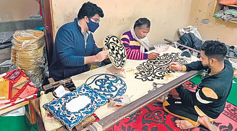 A beading craftsperson at work