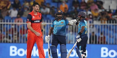 Sri Lanka's Kusal Perera (C) and Charith Asalanka celebrate runs between wicket during Twenty20 World Cup first round match between Sri Lanka and Netherlands in Sharjah, UAE. (Photo | AP)