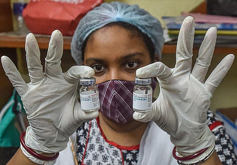 A health worker shows vials of Covaxin at a vaccination centre in Kolkata (Photo | PTI)