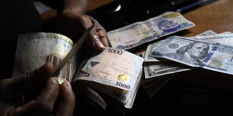A man exchanges Nigeria's currency Naira for US dollars in Lagos, Nigeria. (Photo | AFP)