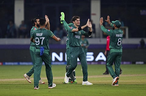 Pakistan's Shaheen Afridi, centre, celebrates with teammates after dismissing Indian cricket captain Virat Kohli. (Photo | AP)