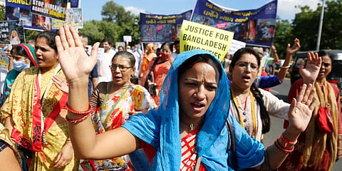 Followers of the International Society for Krishna Consciousness protest against the recent violence against Hindus in Bangladesh. (Photo | AP)