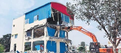 BDA demolishes one of the illegally-constructed commercial buildings at Somashettyhalli on Monday | express