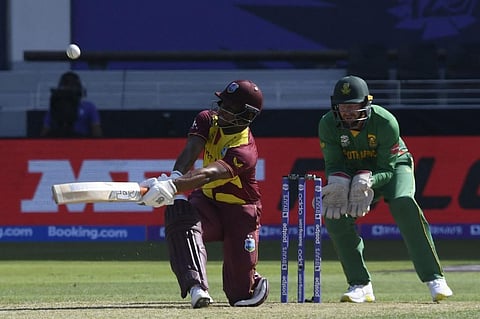 West Indies' Evin Lewis (L) plays a shot during the T20 WC match against South Africa at Dubai International Cricket Stadium, Dubai on October 26, 2021. (Photo | AFP)