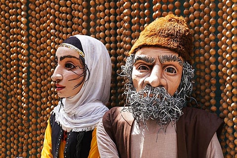 Two large puppets sit off to the side of Iran's pavilion at Expo 2020 in Dubai. (Photo | AP)