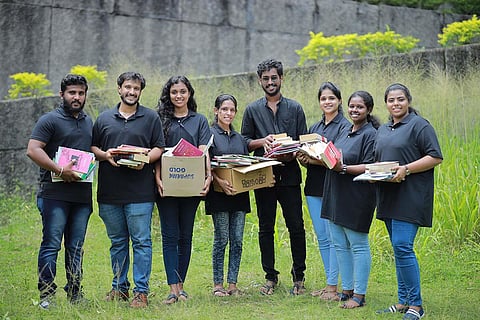 Members of Kanal youth organisation with the books they collected for the library in Palakkad.
