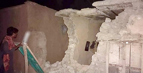 A local resident looks his damaged house following a severe earthquake hit the area, in Harnai, about 100 kilometers from Quetta, Pakistan. (Photo | AP)