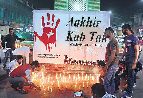Kashmiri Pandits take part in a candle light protest against the killing of civilians belonging to minority communities in Srinagar | PTI