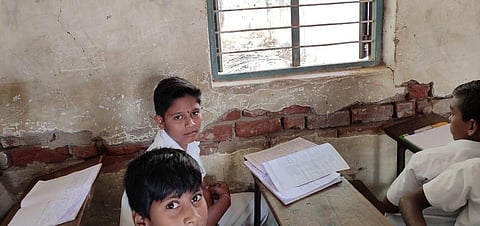 Students in the dilapidated classroom. (Photo | Express)