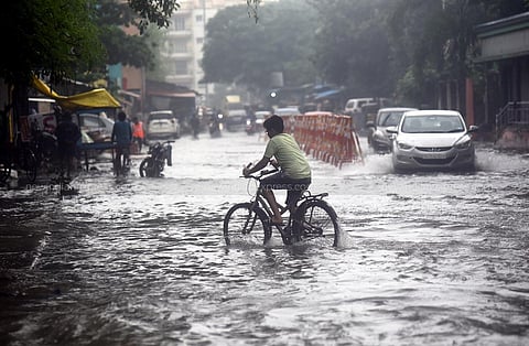 How to navigate this flooded road at Kannigapuram near KK Nagar in Chennai? Do you find the cycle better or will you rather want to hop into a car? (Photo | Martin Louis, EPS)