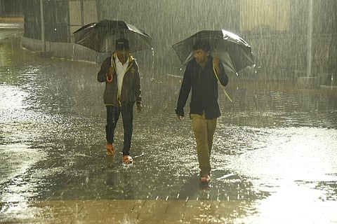 Two men walk through heavy rain in Bengaluru on Monday evening | Nagaraja Gadekal