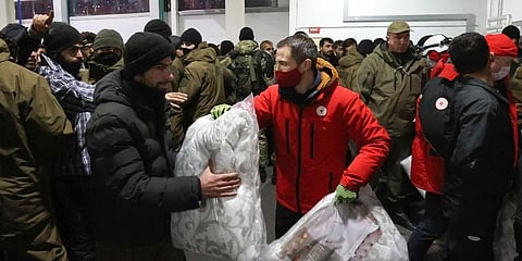 Migrants settle for the night in the logistics center in the checkpoint 'Kuznitsa' at the Belarus-Poland border near Grodno. (Photo | AP)