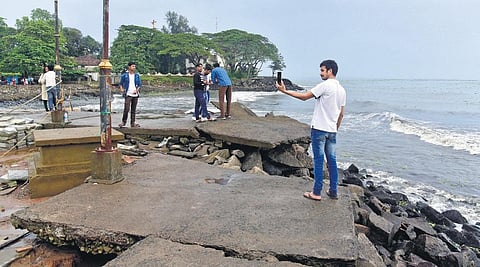 Visitors taking a selfie at run-down Fort Kochi beach