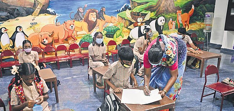 A teacher interacting with a student inside a classroom at CSI Middle School at Saidapet in Chennai on Monday | DEBADATTA MALLICK