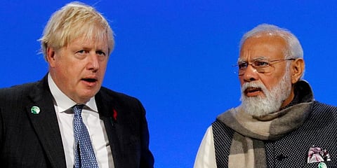 Britain PM Boris Johnson and Indian PM Narendra Modi (R) attend a meeting during the UN Climate Change Conference COP26 in Glasgow, Scotland. (Photo | AP)