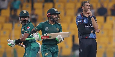 Pakistan's captain Babar Azam and Mohammad Rizwan run between wickets as Namibia's David Wiese watches. (Photo | AP)