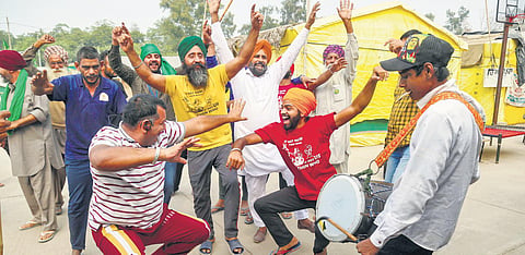 Farmers dance at Tikri border as they celebrate after PM Modi announced repealing of the three farm laws on Friday | Pti