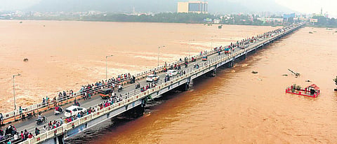 People gather to watch the Palar river in spate | s dinesh
