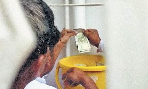 ACB sleuths pull out cash from a drain pipe at the  house of a PWD junior engineer in Kalaburagi  | Special Arrangement