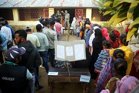 People wait to cast their votes at a polling station during the Tripura Municipal Corporation elections, in Agartala. (Photo | PTI)