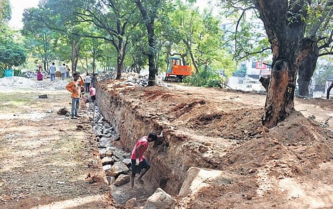 Works on construction of a new boundary  wall in progress at Indira Park on Lower Tank Bund. (Photo | Express, S Senbagapandiyan)