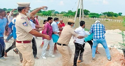 Police try to intervene as  TRS workers  rough up farmers of Devannapet village on Wednesday for refusing to let the ruling party use their fields for the upcoming Vijaya Garjana programme