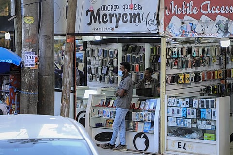 A man stands outside a mobile phone accessory shop in the Piazza old town area of  the capital  Addis Ababa, Ethiopia. (Photo I AP)