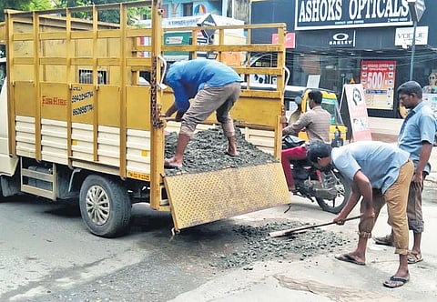Workers patching up potholes on a road in the city | special arrangement