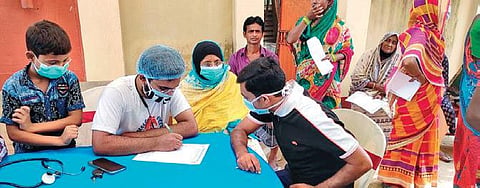 Dr Golam Ahmed Kibria (in white tee) with underprivileged patients.